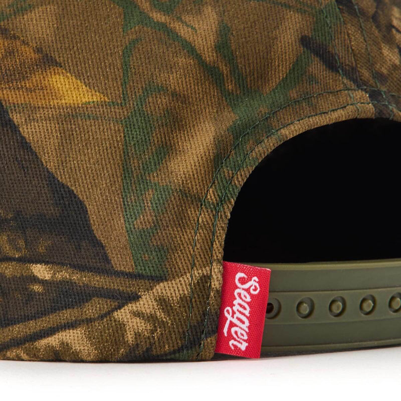 Care label on USA Snapback Camo Hat showing Red label with white script lettering on hat interior seam - Slowride Supply