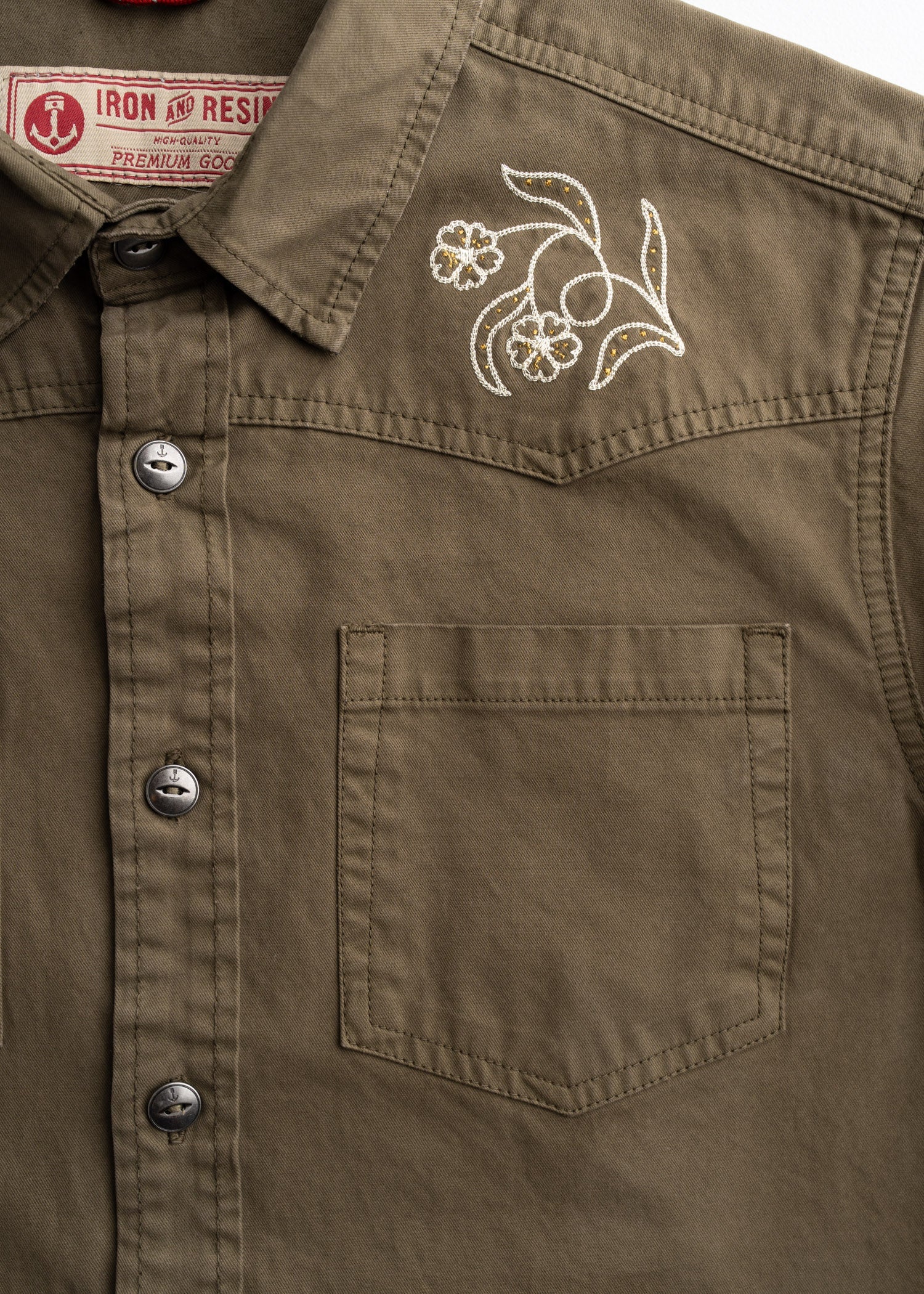 Close-up of Westy Shirt S/S Woven Light Khaki S/S Woven showing White and gold embroidered floral scroll on chest pocket