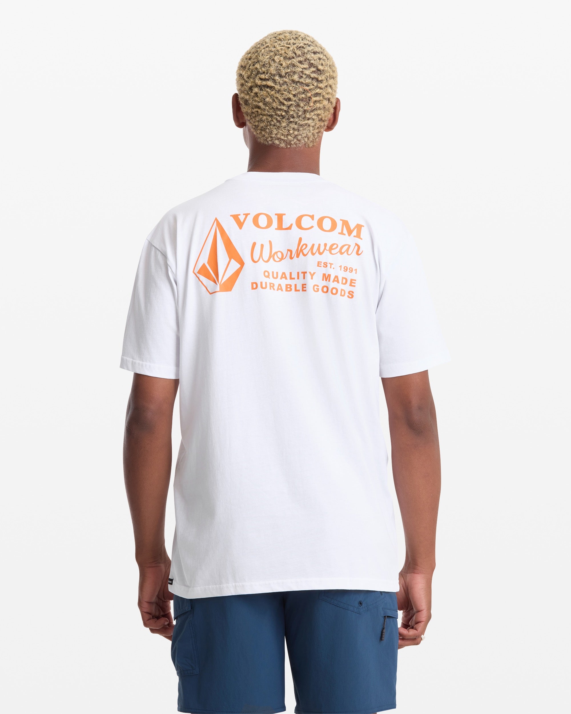 Person wearing Workwear White Tee, Person wearing white tee standing against neutral studio backdrop - Slowride Supply