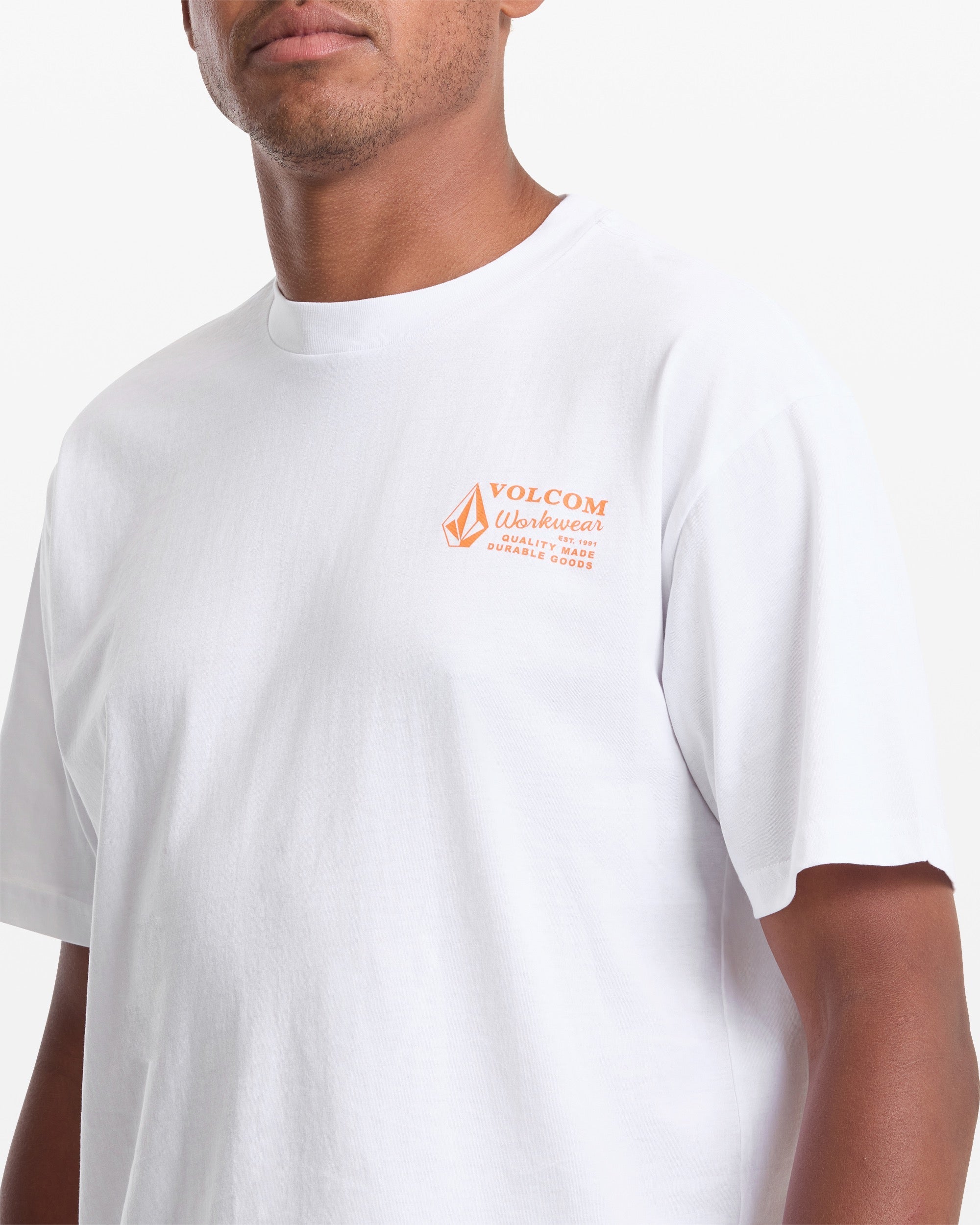 Person wearing Workwear White Tee, Man wearing white tee against plain white studio background - Slowride Supply