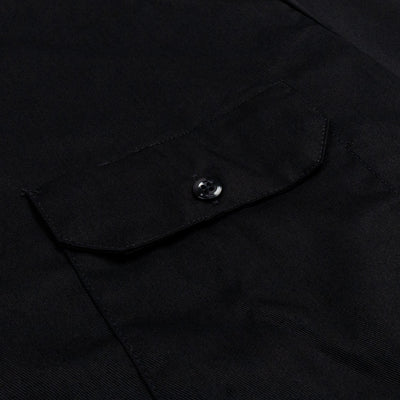 Close-up of Woven Twill Shirt S/S Woven Black S/S Woven showing Chest pocket with metal snap button closure and angled flap