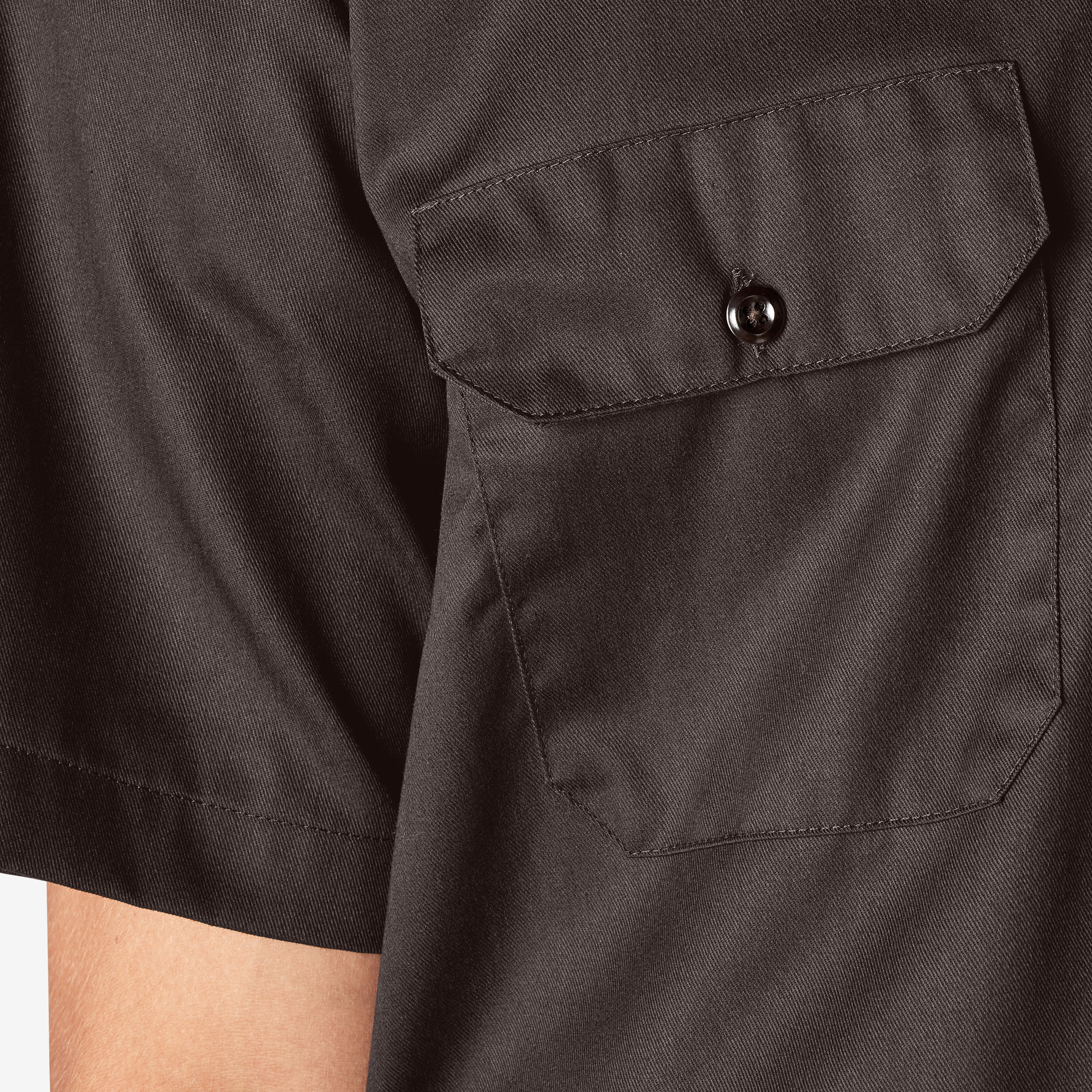 Close-up of Woven Twill Shirt S/S Woven Black S/S Woven showing Charcoal twill chest pocket with button closure and diagonal
