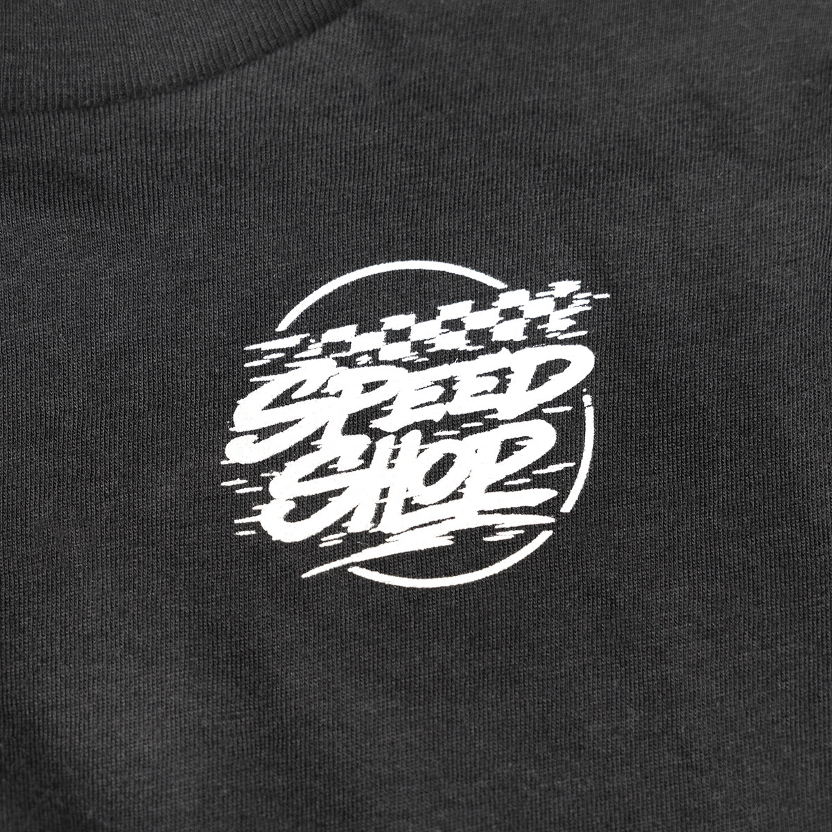 Close-up of Youth Burner Tee Kids Black Kids Tee showing White embroidered script graphic with speed lines and circular