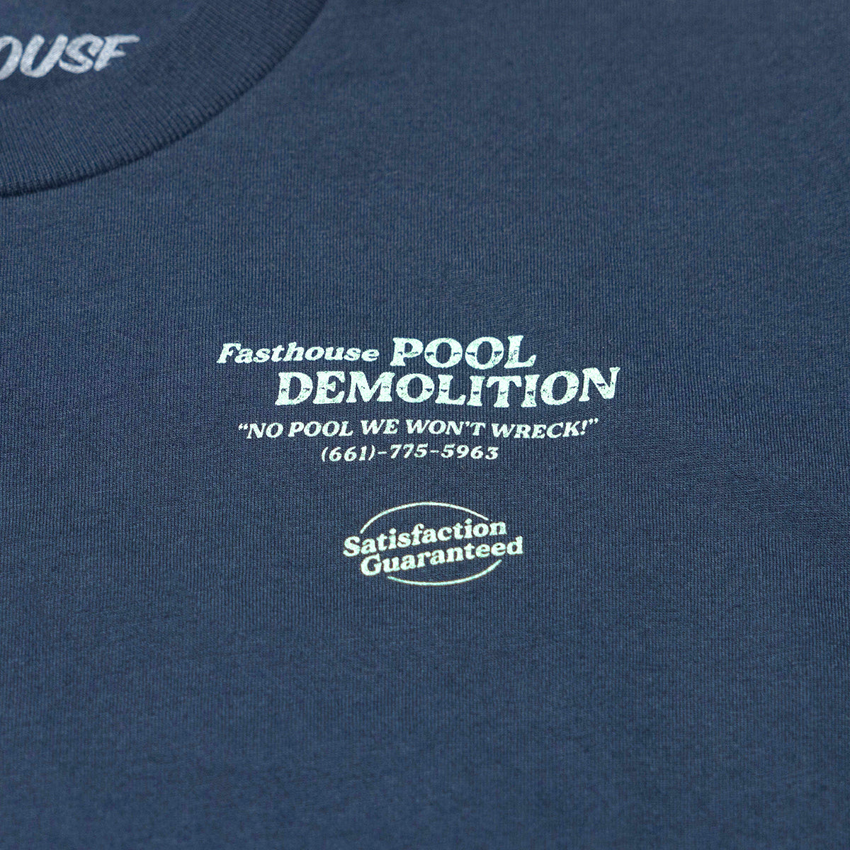 Close-up of Youth Demolition Tee Kids Navy Kids Tee showing White embroidered text and oval badge on navy cotton jersey,
