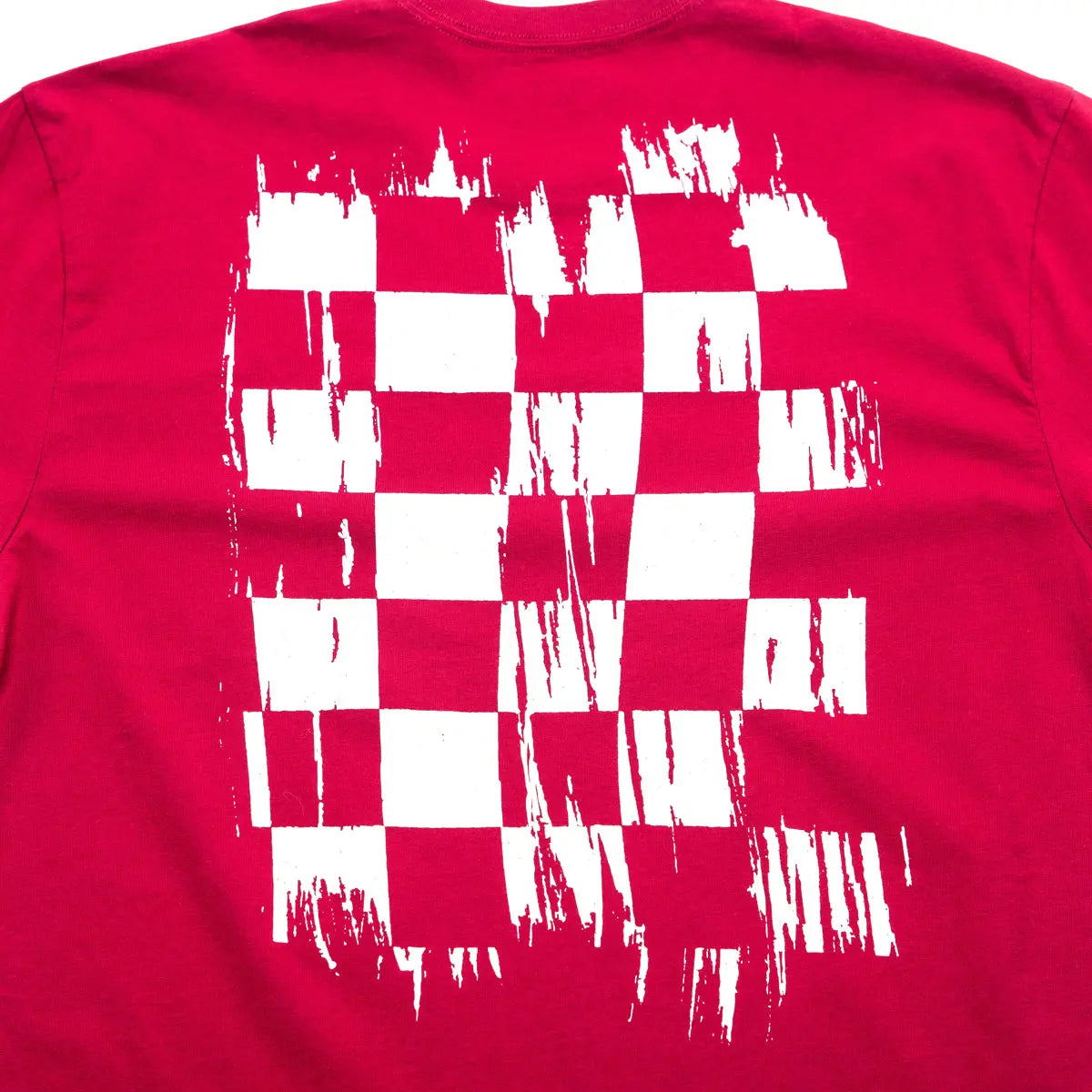 Close-up of Youth Fray Tee Cardinal Kids Kids Tee showing Red with white distressed checkered flag graphic and cityscape