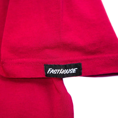 Close-up of Youth Fray Tee Cardinal Kids Kids Tee showing Black woven label with white handstyle text on red garment hem -