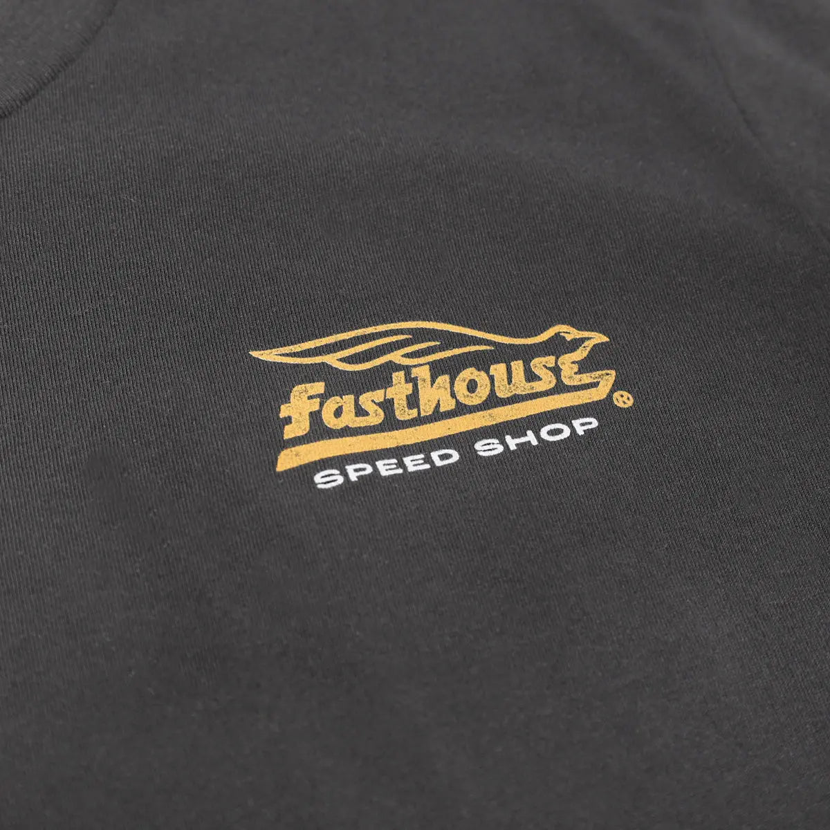 Close-up of Youth Gilmore Tee Kids Black Kids Tee showing Gold and white embroidered logo with stylized bird and text on