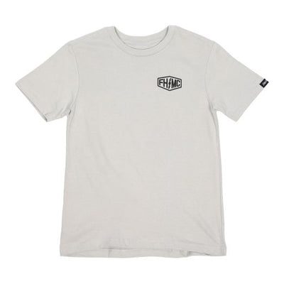 Close-up of Youth Gilmore Tee Kids Black Kids Tee showing Cream tee with small black hexagonal shield logo on chest and