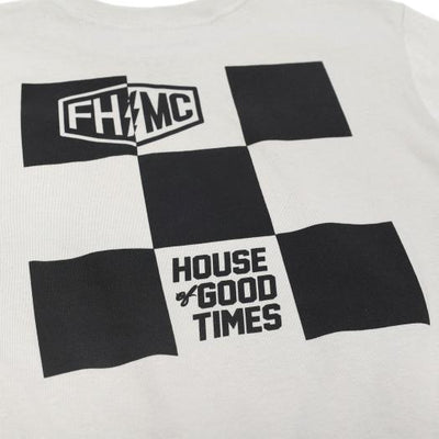 Close-up of Youth Gilmore Tee Kids Black Kids Tee showing Black and white checkered flag graphic with "FHMC" shield logo and