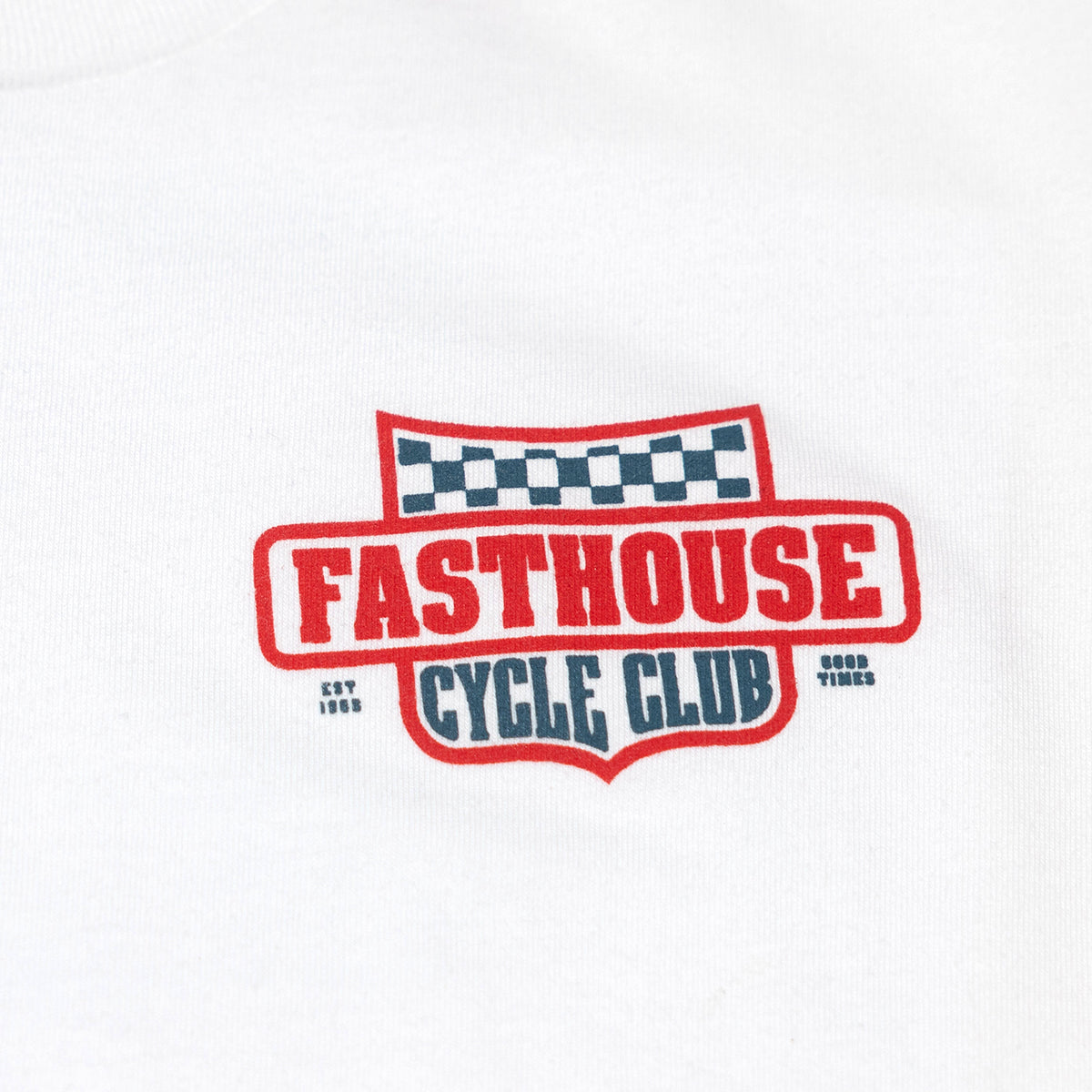 Close-up of Youth Krest Tee Kids White Kids Tee showing Red embroidered badge with checkered flag above, navy text reading