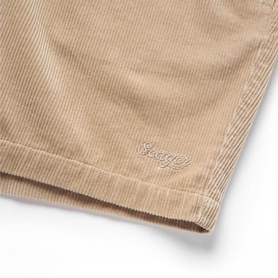 Close-up of Yuma Shorts Dark Olive Shorts showing Tan ribbed fabric with embroidered script logo on leg - Slowride Supply
